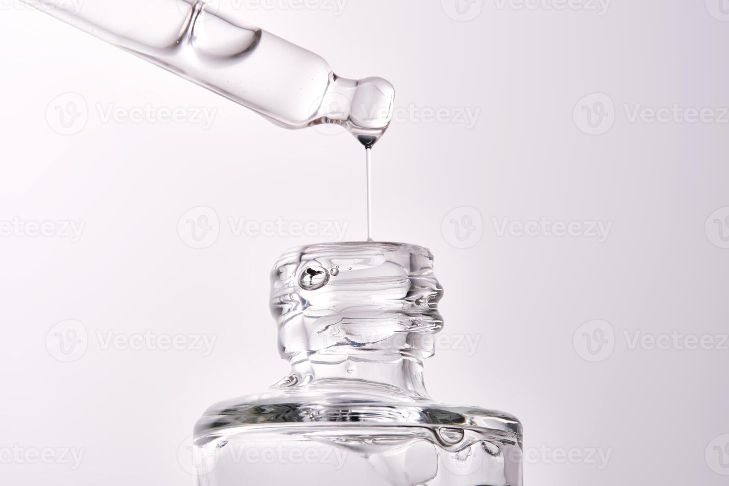 Close-up of a cosmetic bottle with a pipette showing the texture of the serum. photo