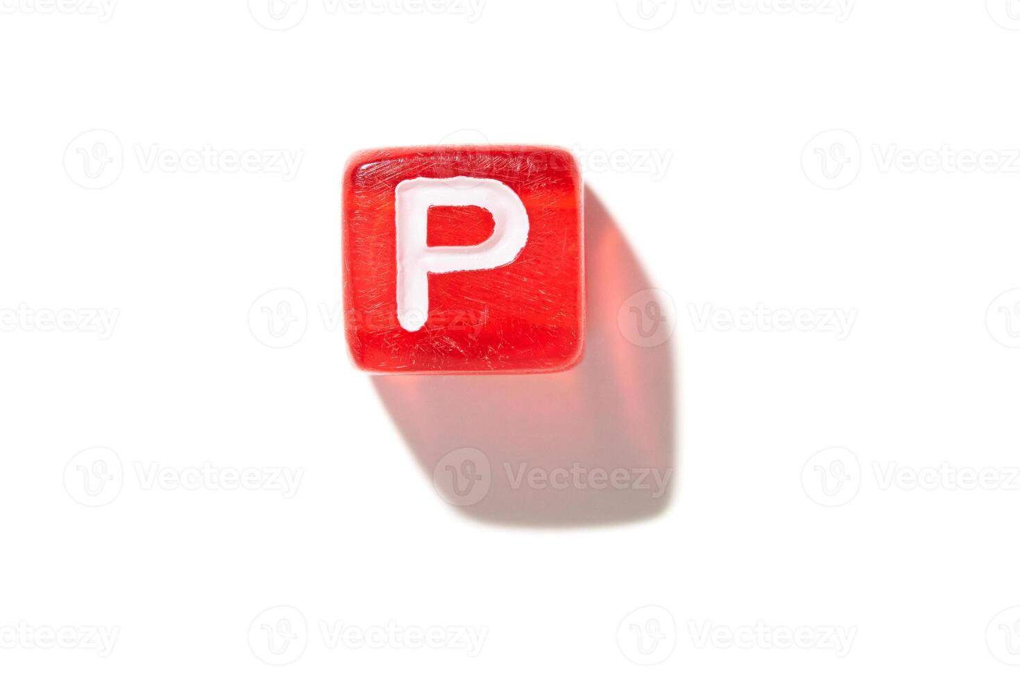 Red dice with letter p on white background showing shadow and minimalist design perfect for typography concepts photo