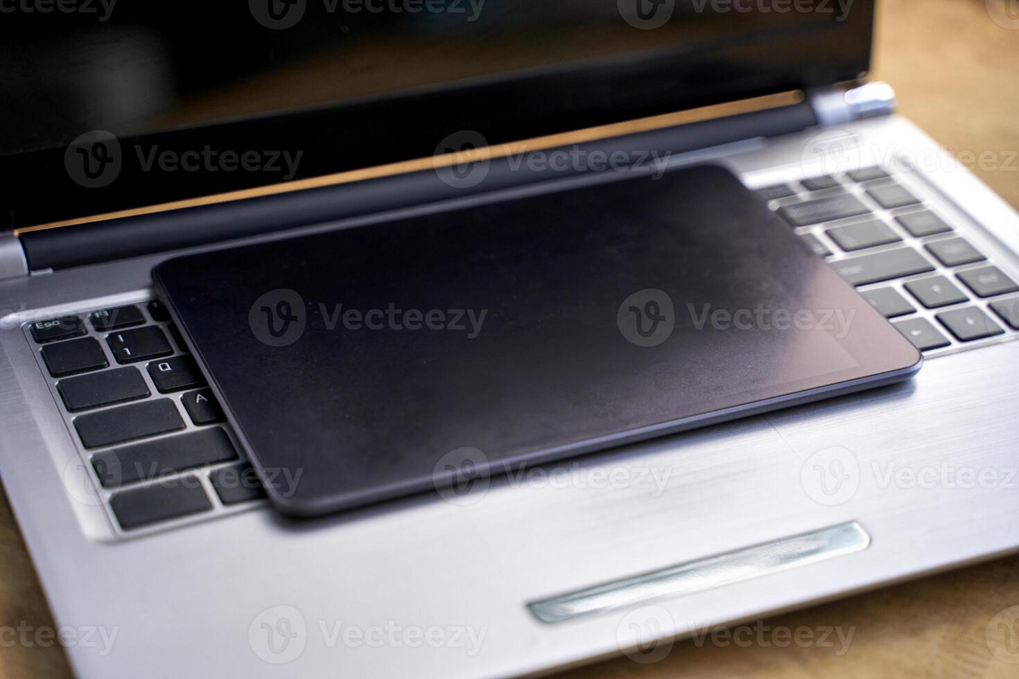 Digital workspace. closed laptop with tablet on keyboard for modern technology and efficient office setup. photo
