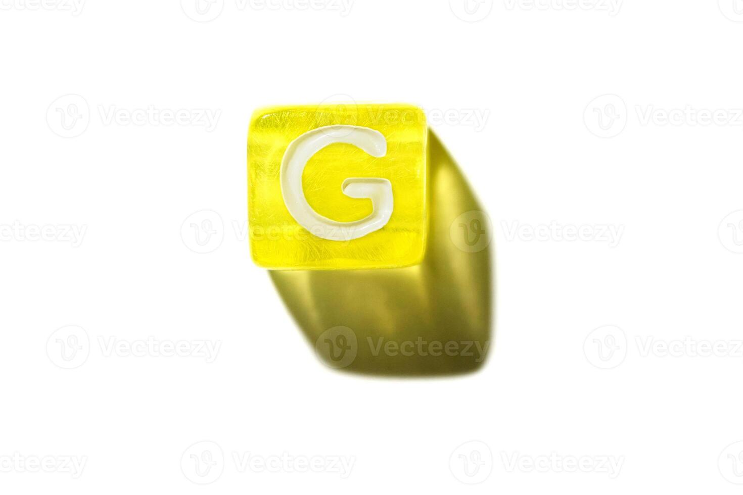 Yellow block with letter g casting shadow on white background. alphabet and learning concept photo