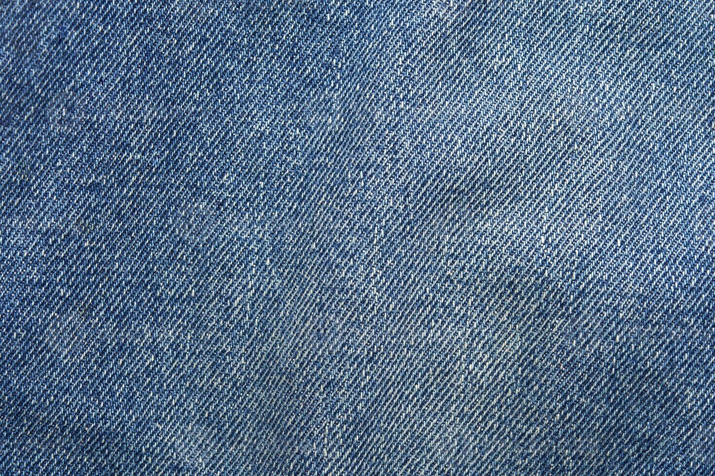 Close-up texture of blue denim fabric with detailed weave pattern for fashion and textile design inspiration. photo
