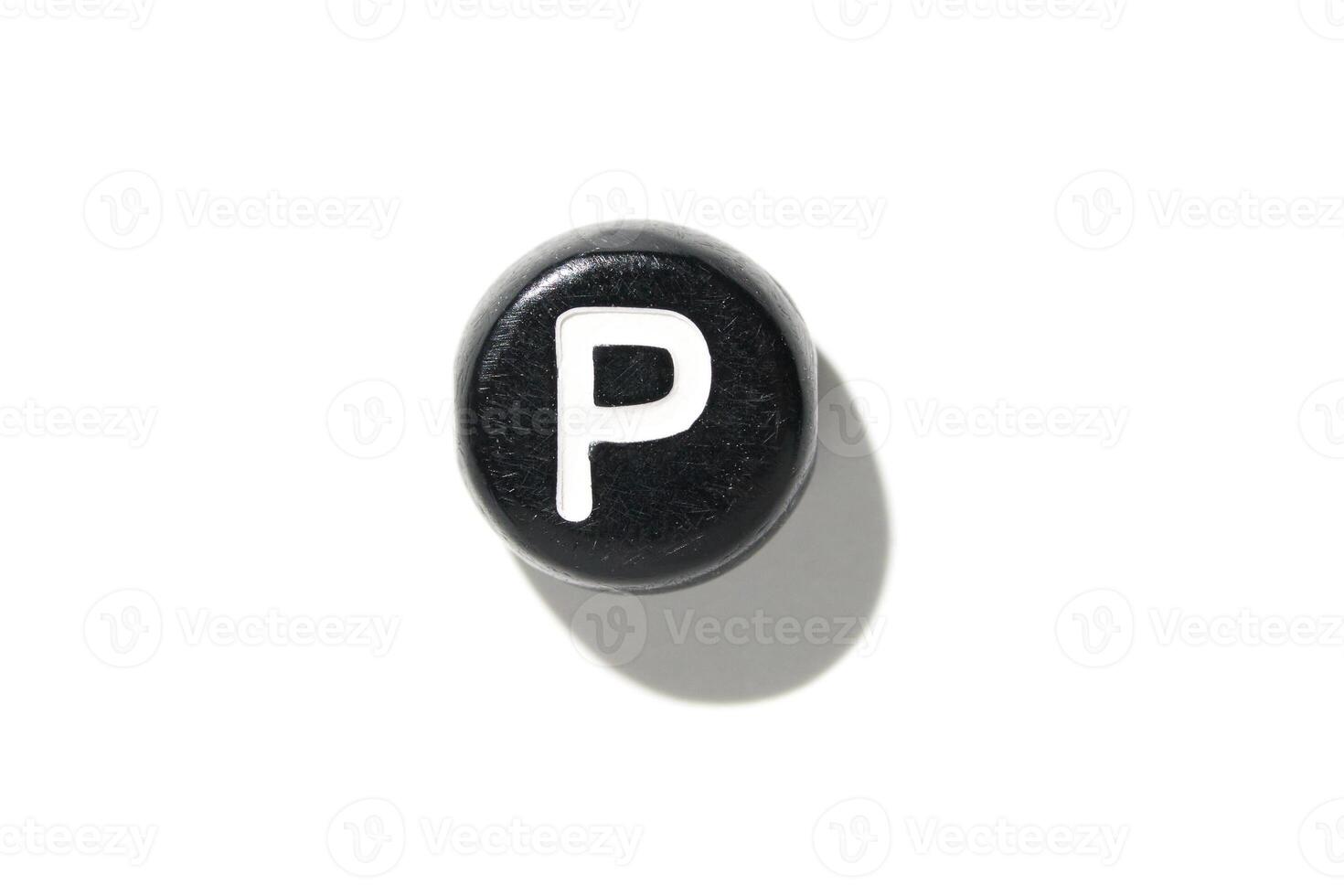 Black button with white letter p isolated on white background with shadow creating bold contrast and minimalist design photo