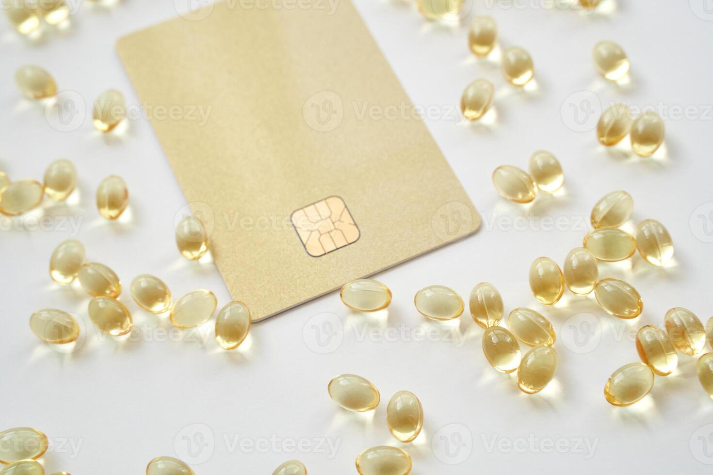 Innovative payment concept. credit card chip surrounded by yellow gel capsules on white background photo