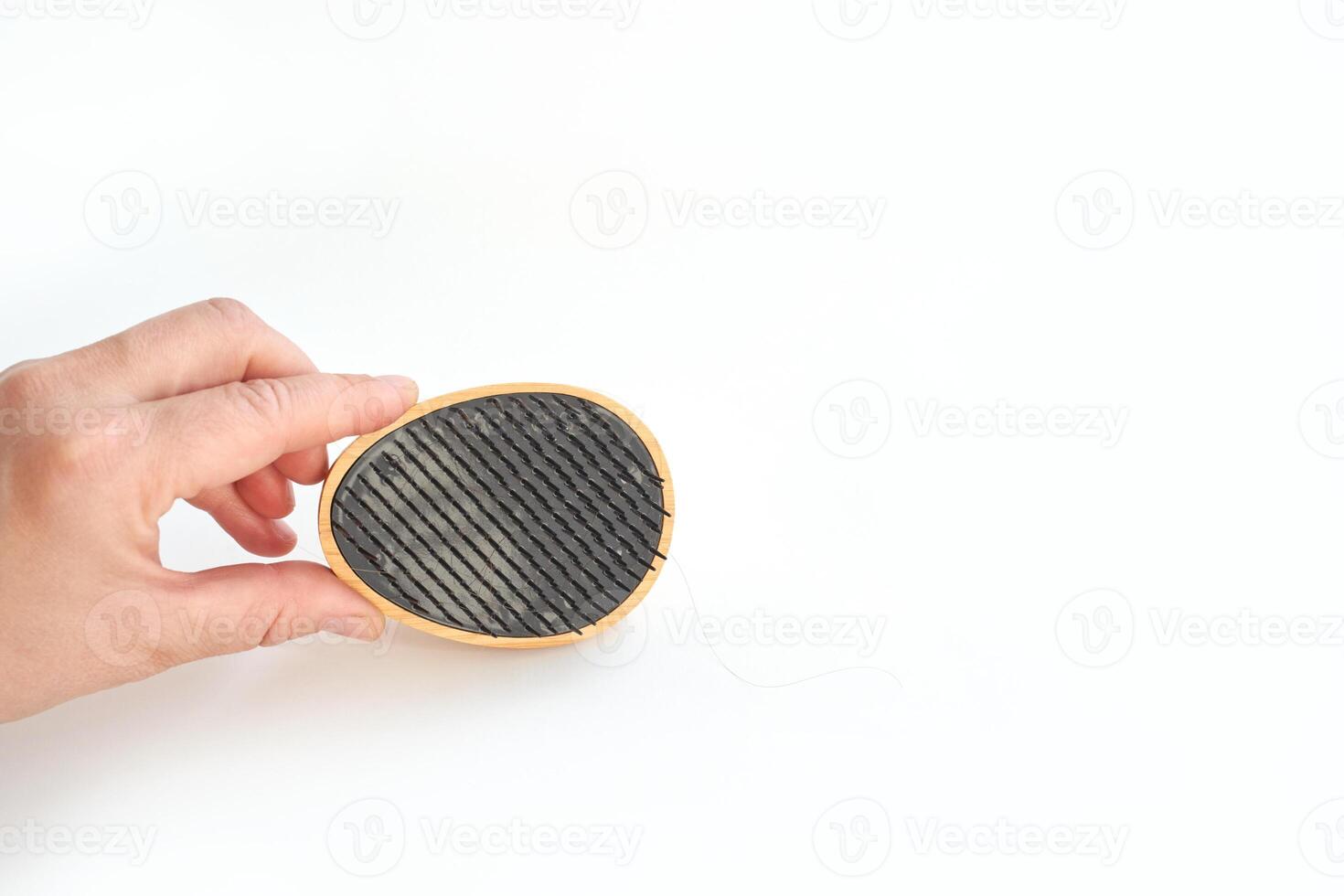 Hand holding charcoal air purifier filter against white background for clean fresh air photo
