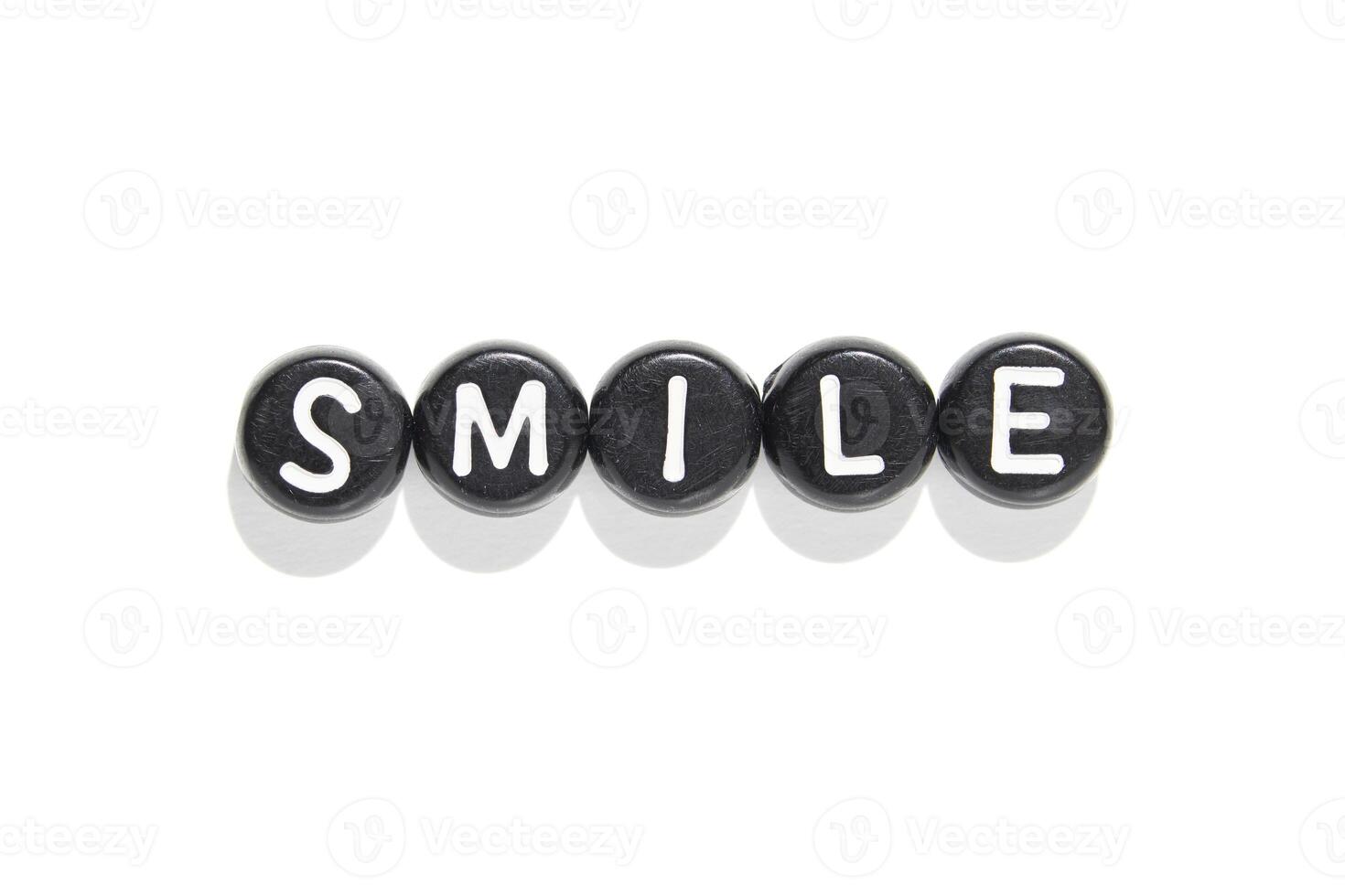 Smile in black and white. letter beads on white background capture simplicity and positivity in minimalist design photo