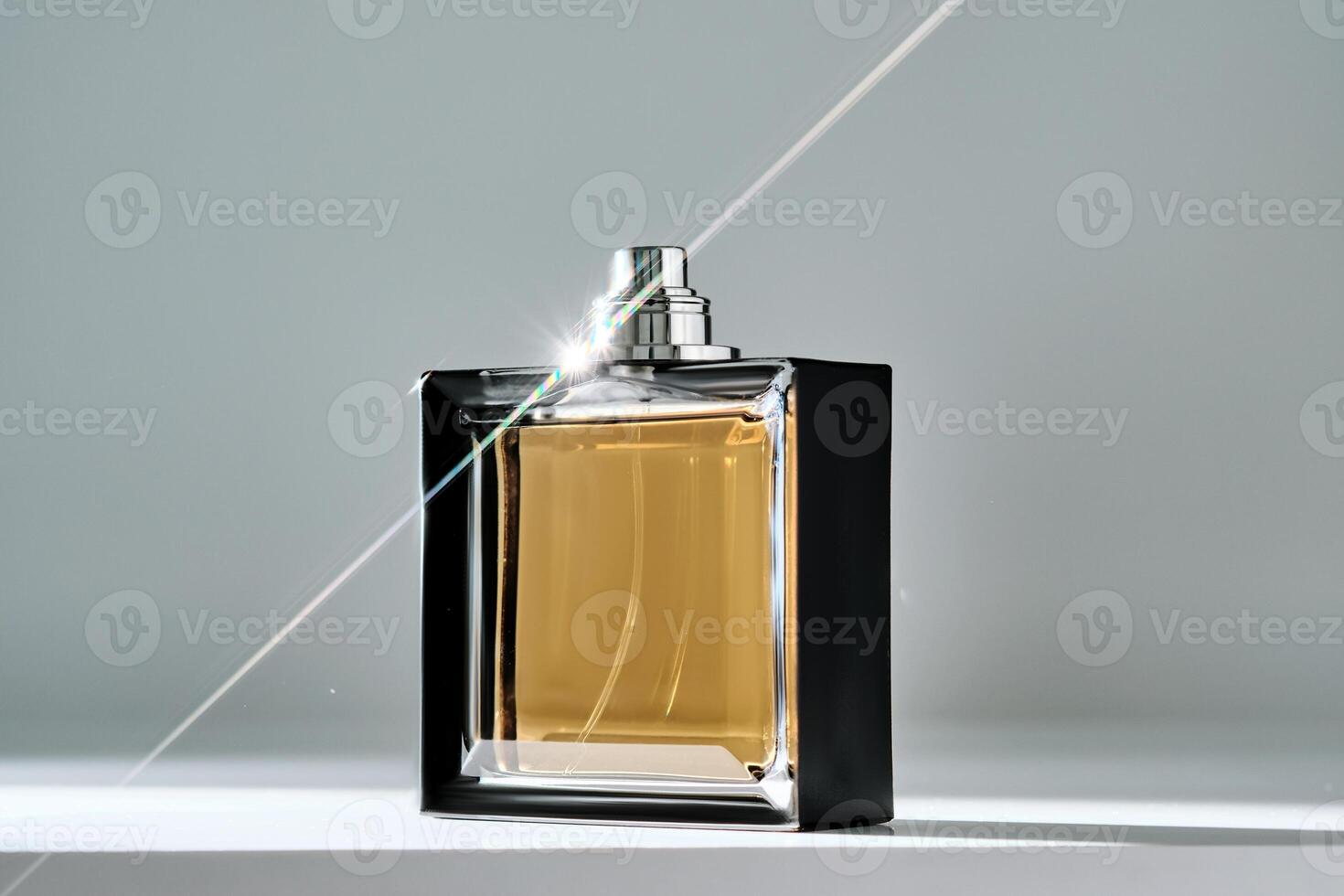 A bottle of yellow perfume with a beautiful highlight. photo