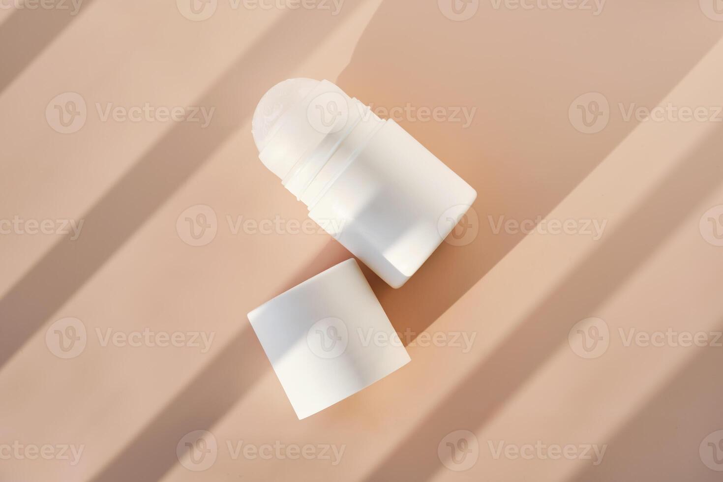 Roll-on deodorant on a purple background with shadow stripes. photo