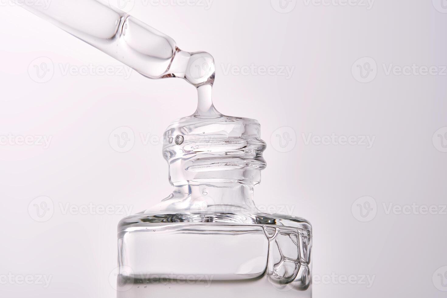 Close-up of a cosmetic bottle with a pipette showing the texture of the serum. photo