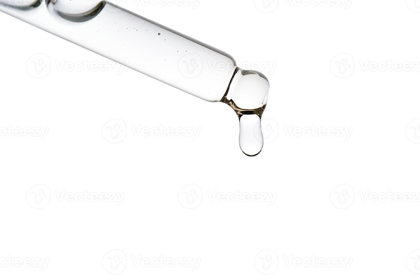 Dropper pipette with delicious serum with bubbles close-up. photo