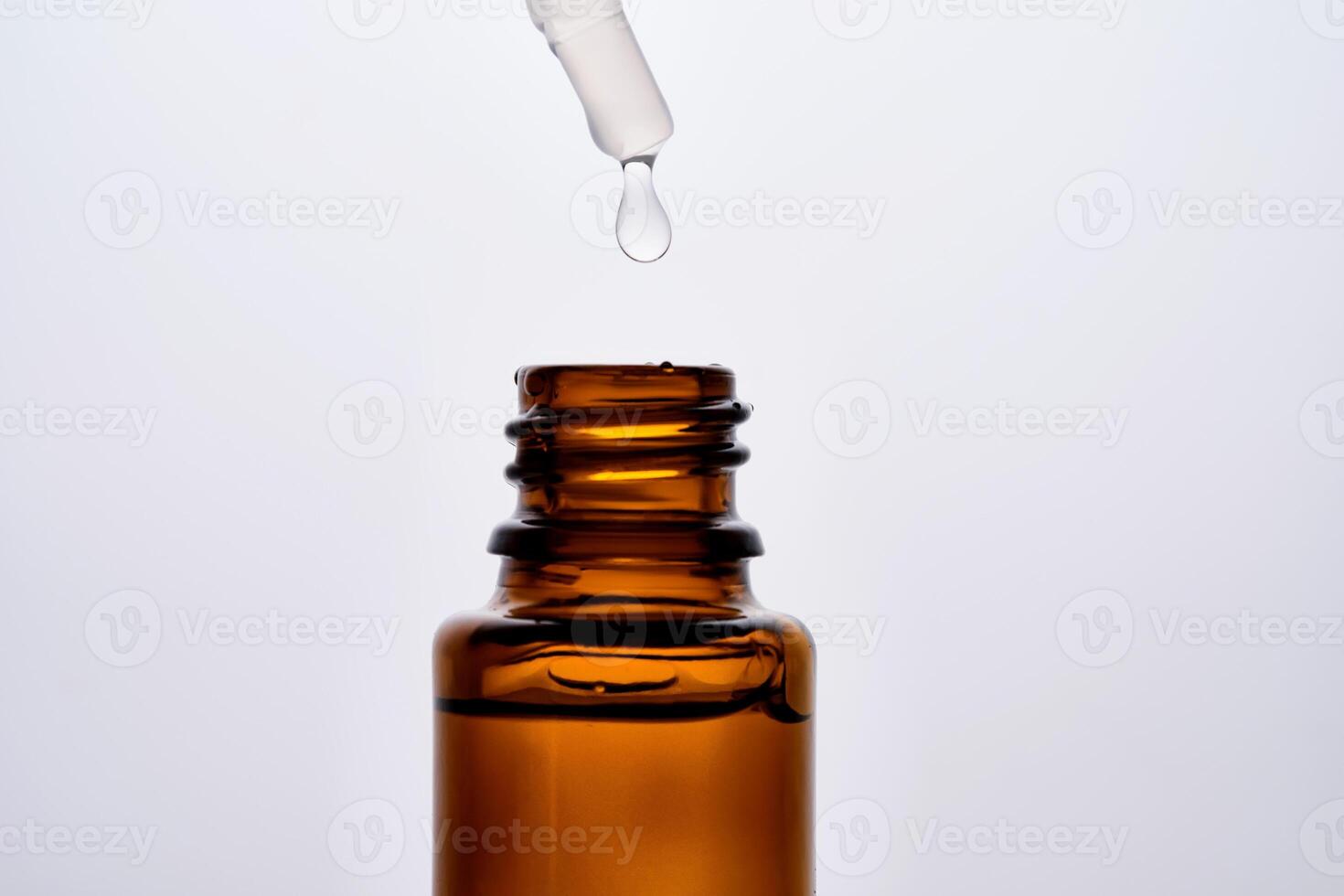 Close-up of a brown cosmetic bottle with a pipette. photo