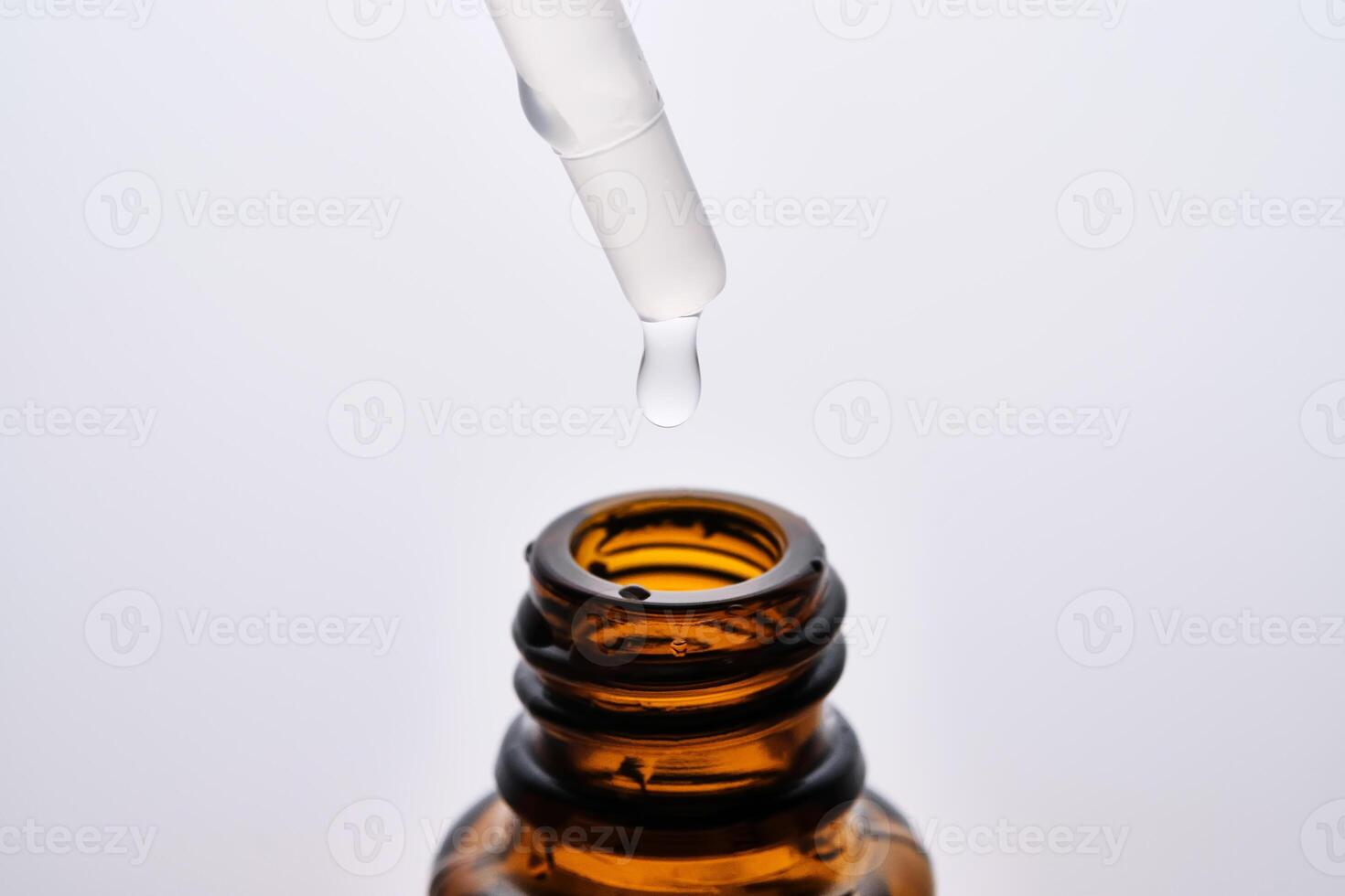 Close-up of a brown cosmetic bottle with a pipette. photo