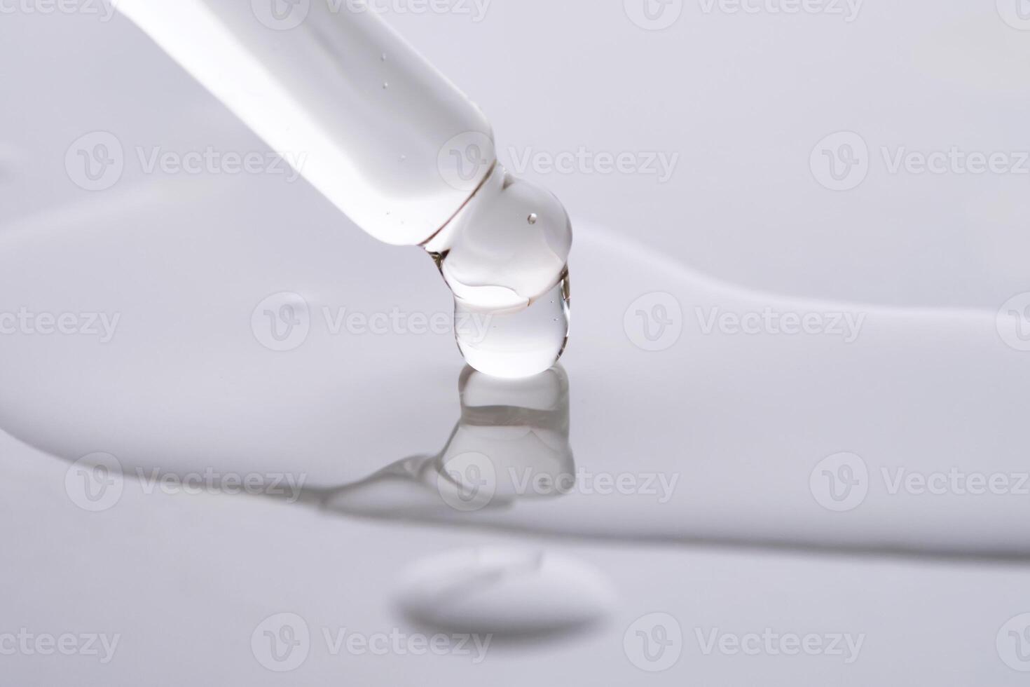 Dropper pipette with delicious serum with drop close-up. photo