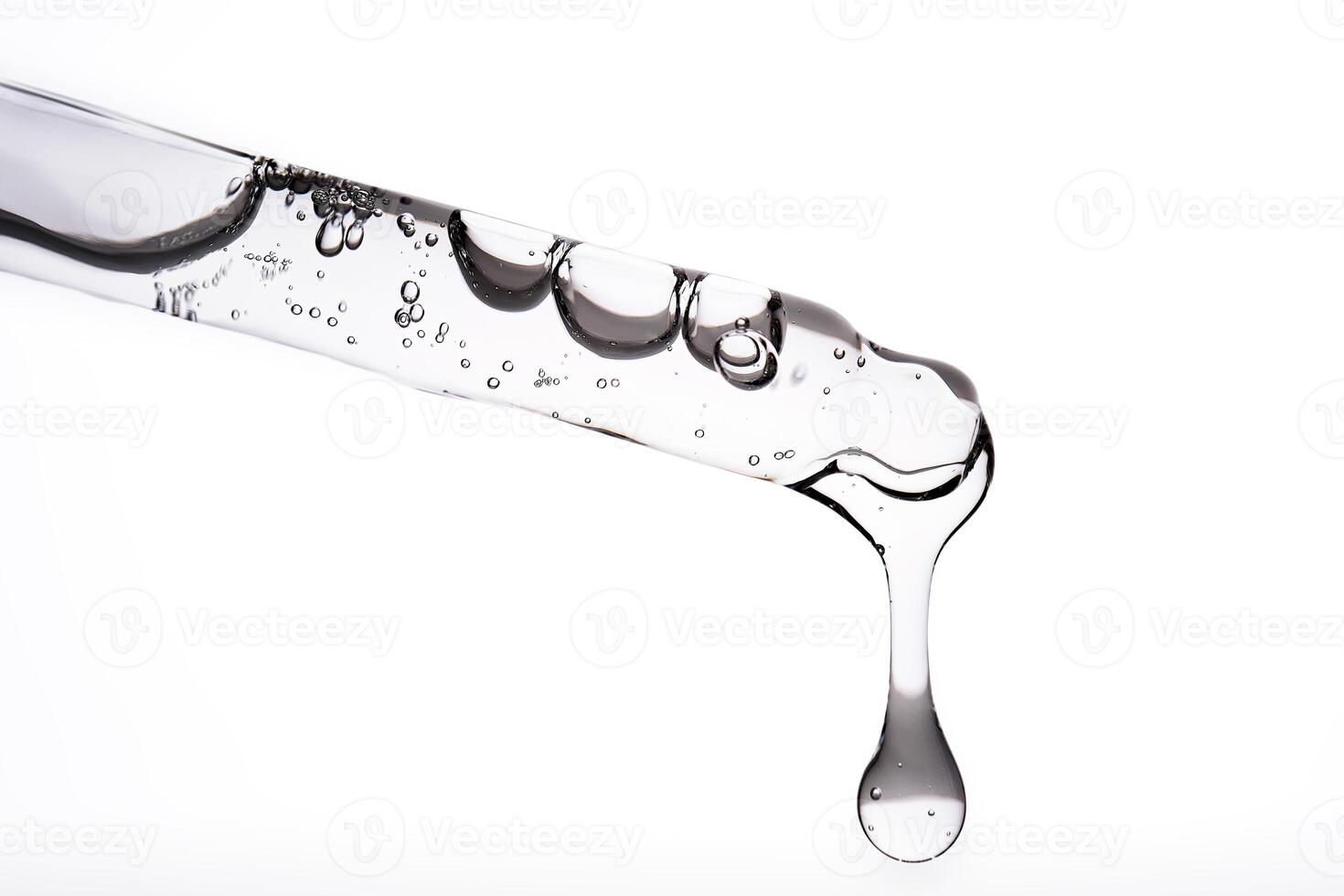 Dropper pipette with delicious serum with bubbles close-up. photo