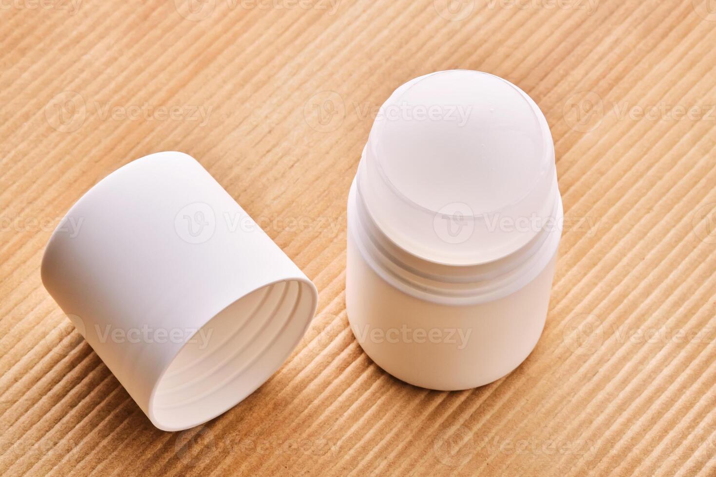 Roll-on deodorant on a background with beige grooves. photo