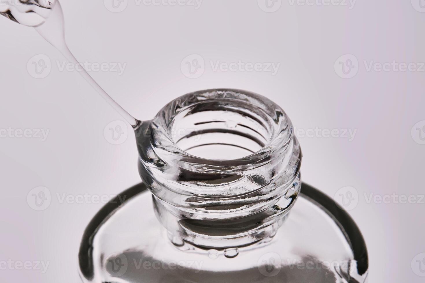 Close-up of a cosmetic bottle with a pipette showing the texture of the serum. photo