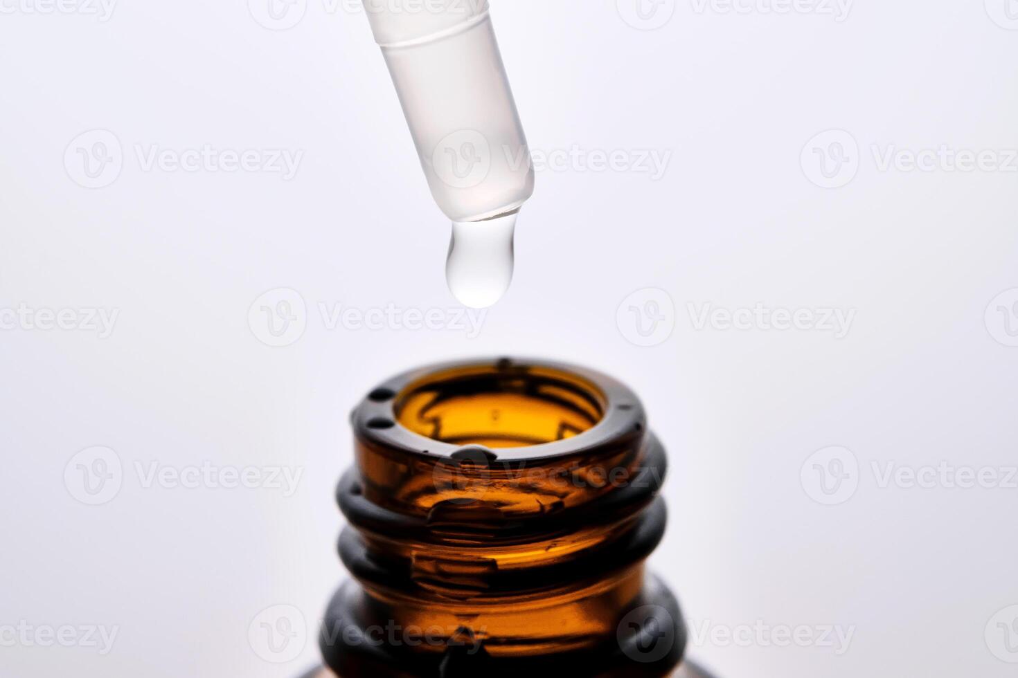 Close-up of a brown cosmetic bottle with a pipette. photo
