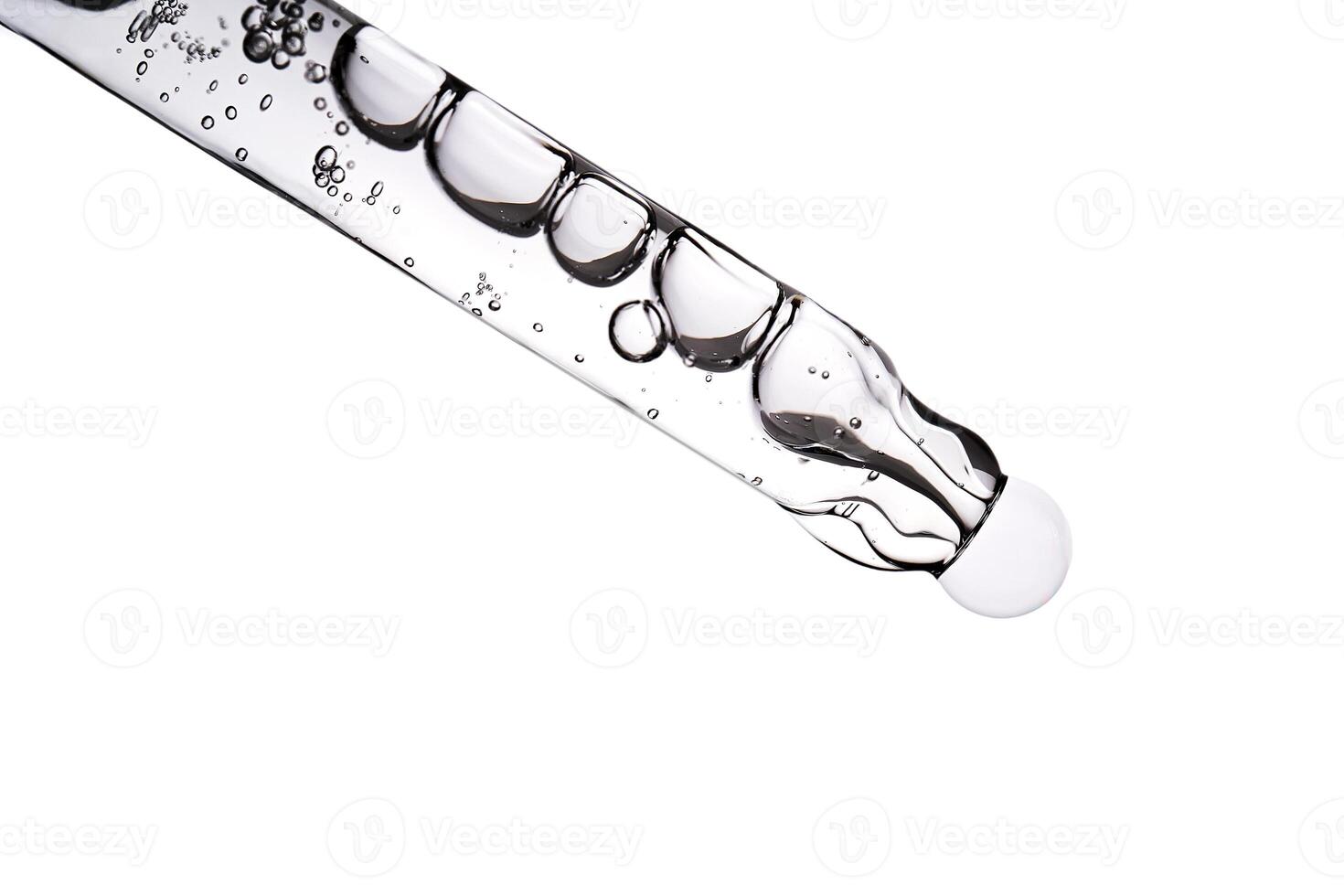 Dropper pipette with delicious serum with bubbles close-up. photo