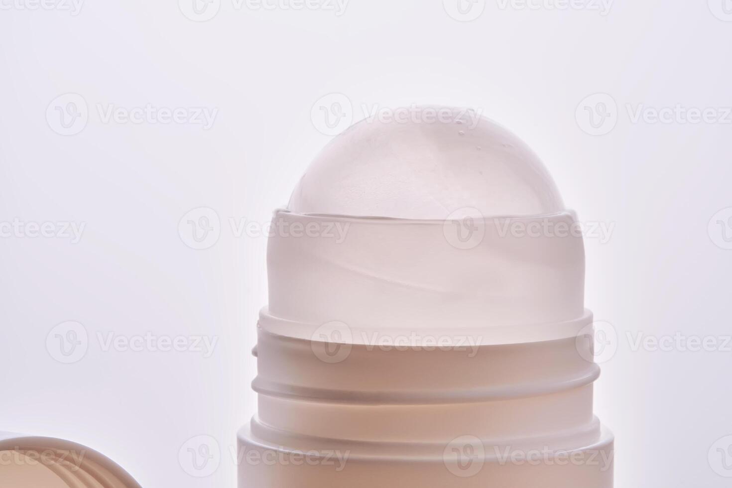 Roll-on deodorant on a background with beige grooves. photo