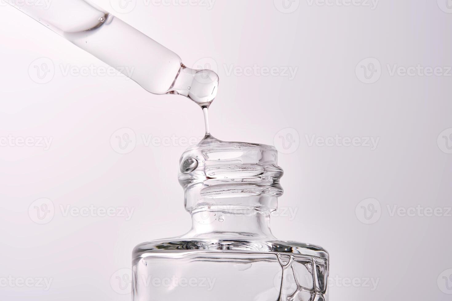 Close-up of a cosmetic bottle with a pipette showing the texture of the serum. photo