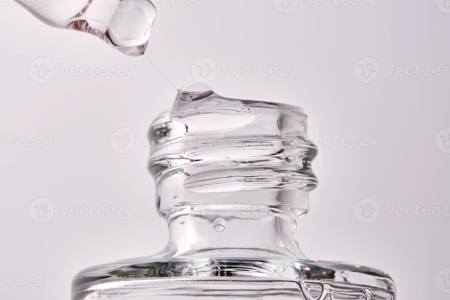 Close-up of a cosmetic bottle with a pipette showing the texture of the serum. photo