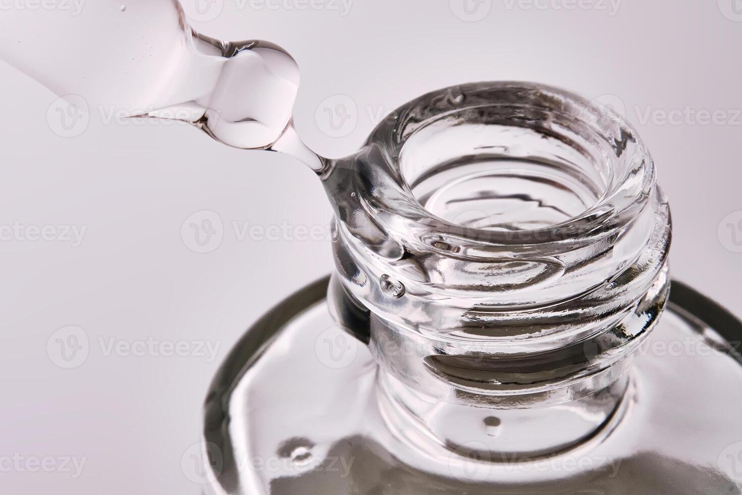 Close-up of a cosmetic bottle with a pipette showing the texture of the serum. photo