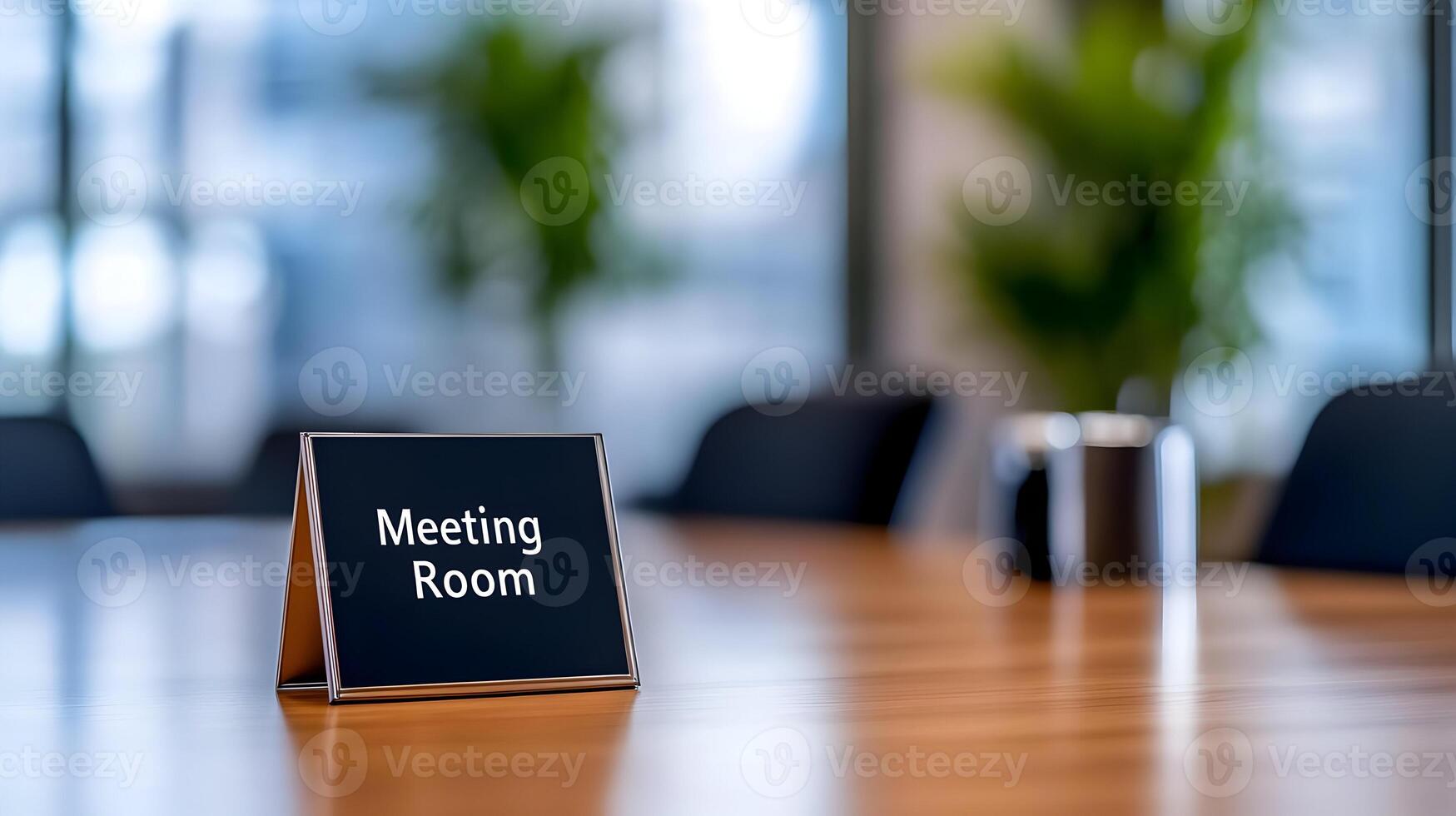 Meeting Room sign on office glass wall with empty collaboration workspace, large table, and armchairs in background. photo