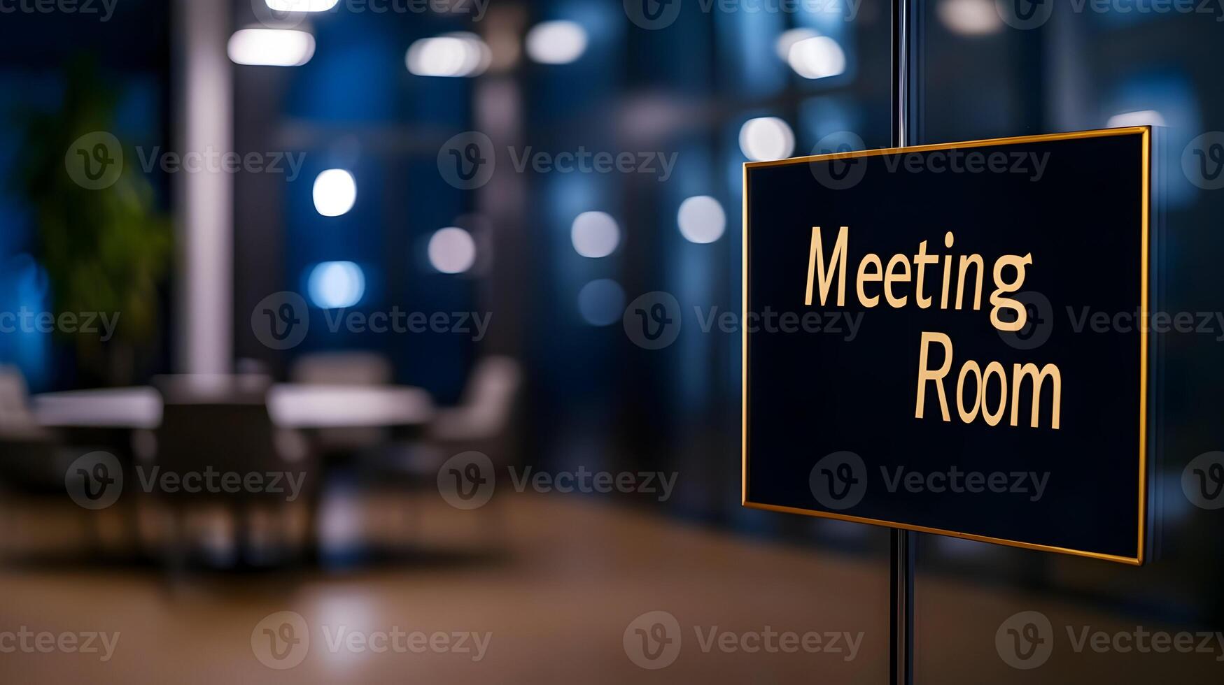 Meeting Room sign on office glass wall with empty collaboration workspace, large table, and armchairs in background. photo