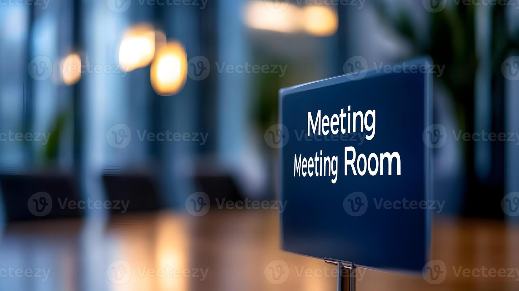Meeting Room sign on office glass wall with empty collaboration workspace, large table, and armchairs in background. photo