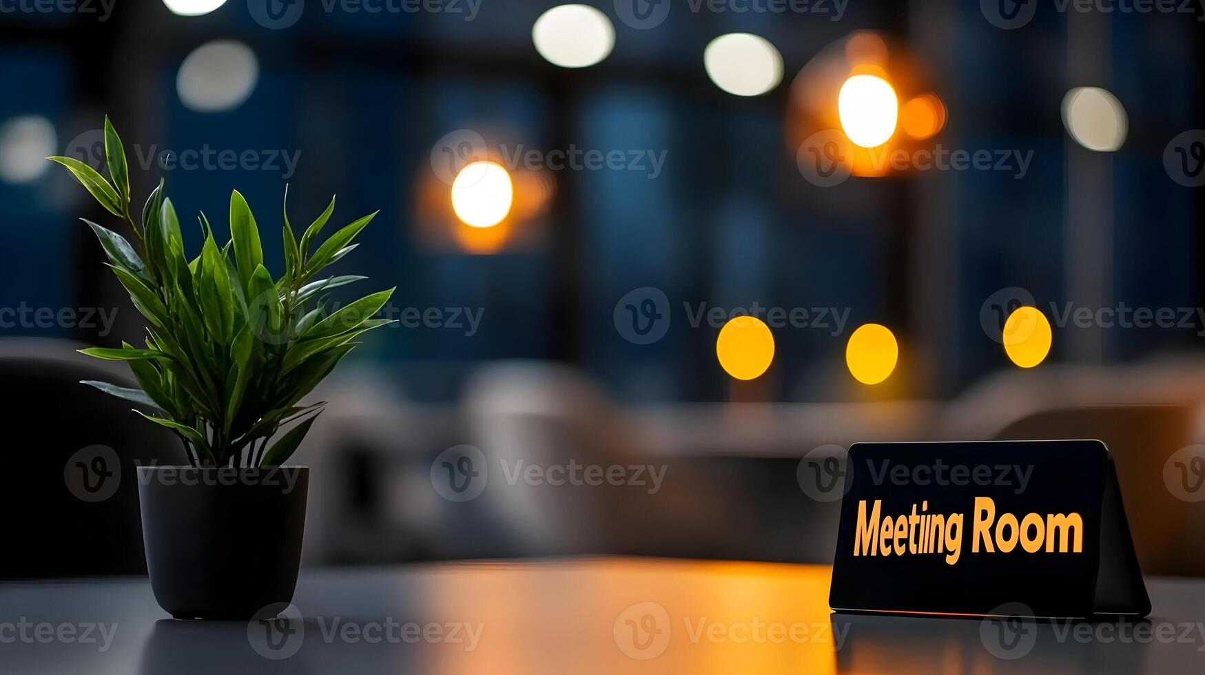 Meeting Room sign on office glass wall with empty collaboration workspace, large table, and armchairs in background. photo