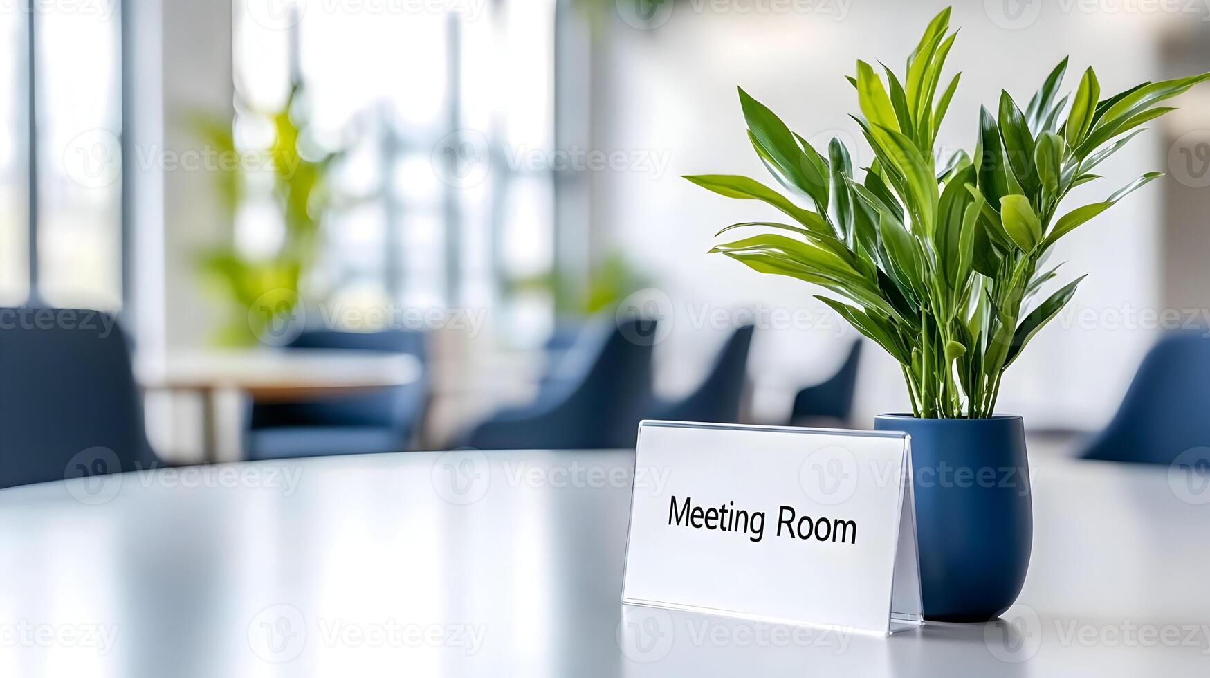 Meeting Room sign on office glass wall with empty collaboration workspace, large table, and armchairs in background. photo