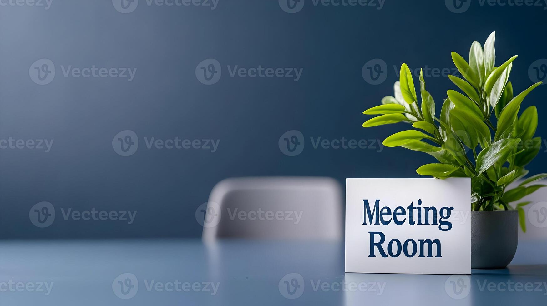 Meeting Room sign on office glass wall with empty collaboration workspace, large table, and armchairs in background. photo