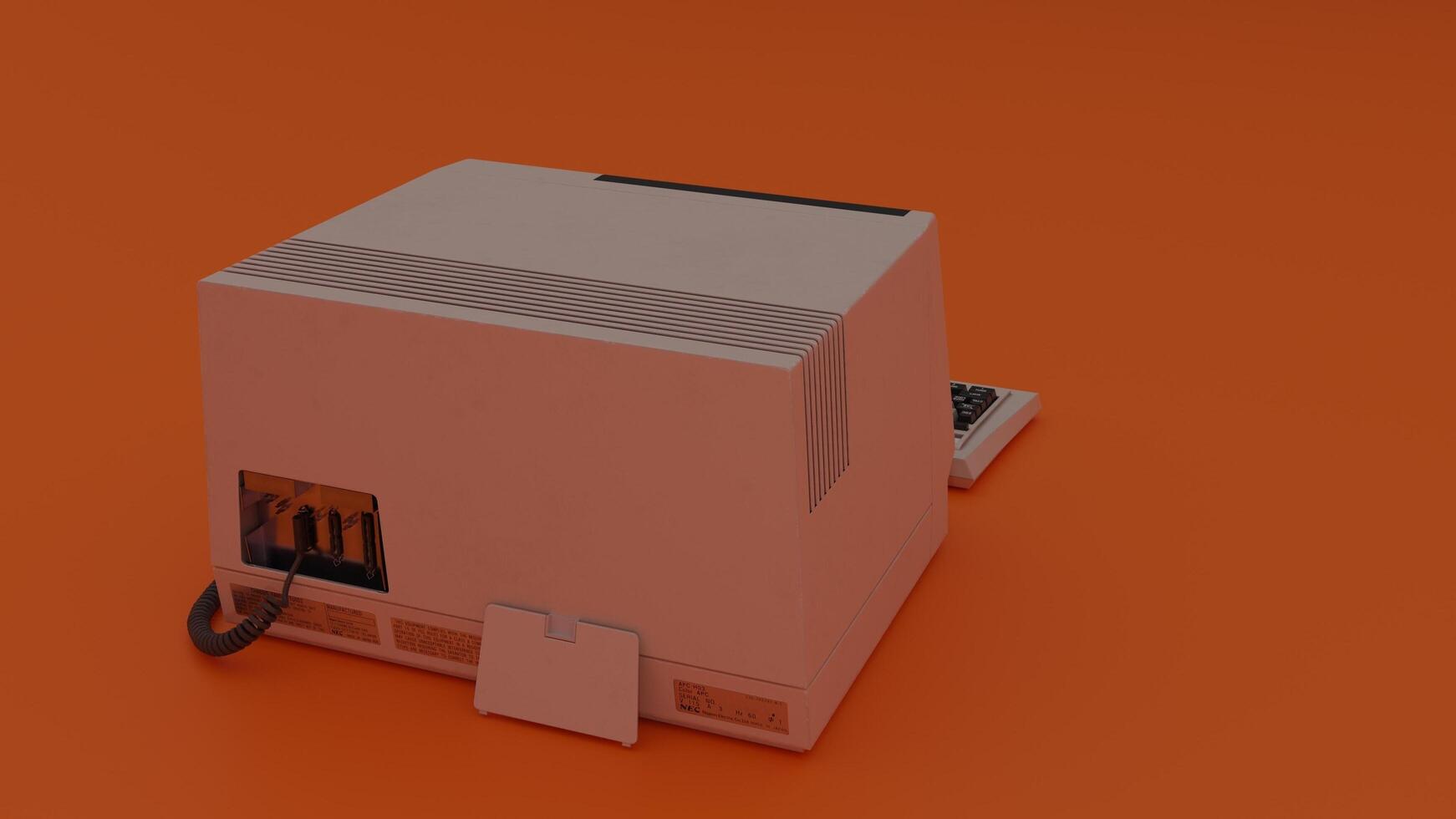 A small computer on an orange surface photo