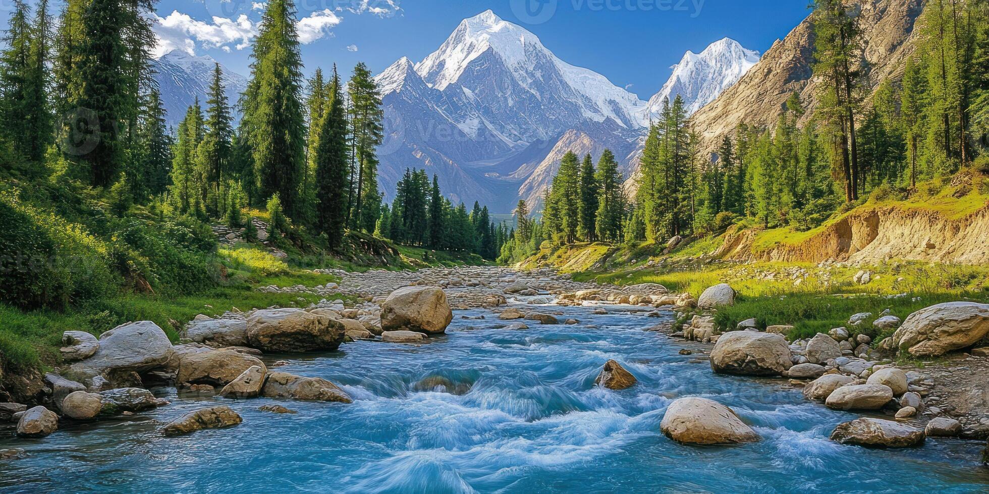 A turquoise river rushes through a rocky valley, framed by evergreen trees and snow-capped mountains. photo