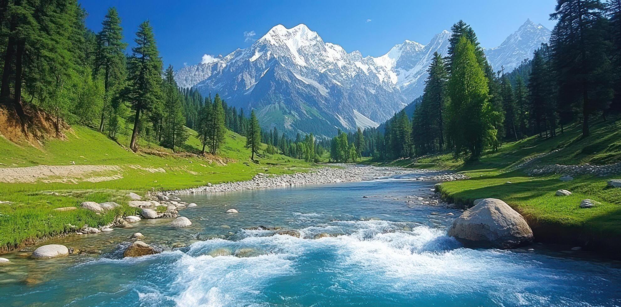 A River Flows Through A Mountainous Valley With Snow-Capped Peaks photo