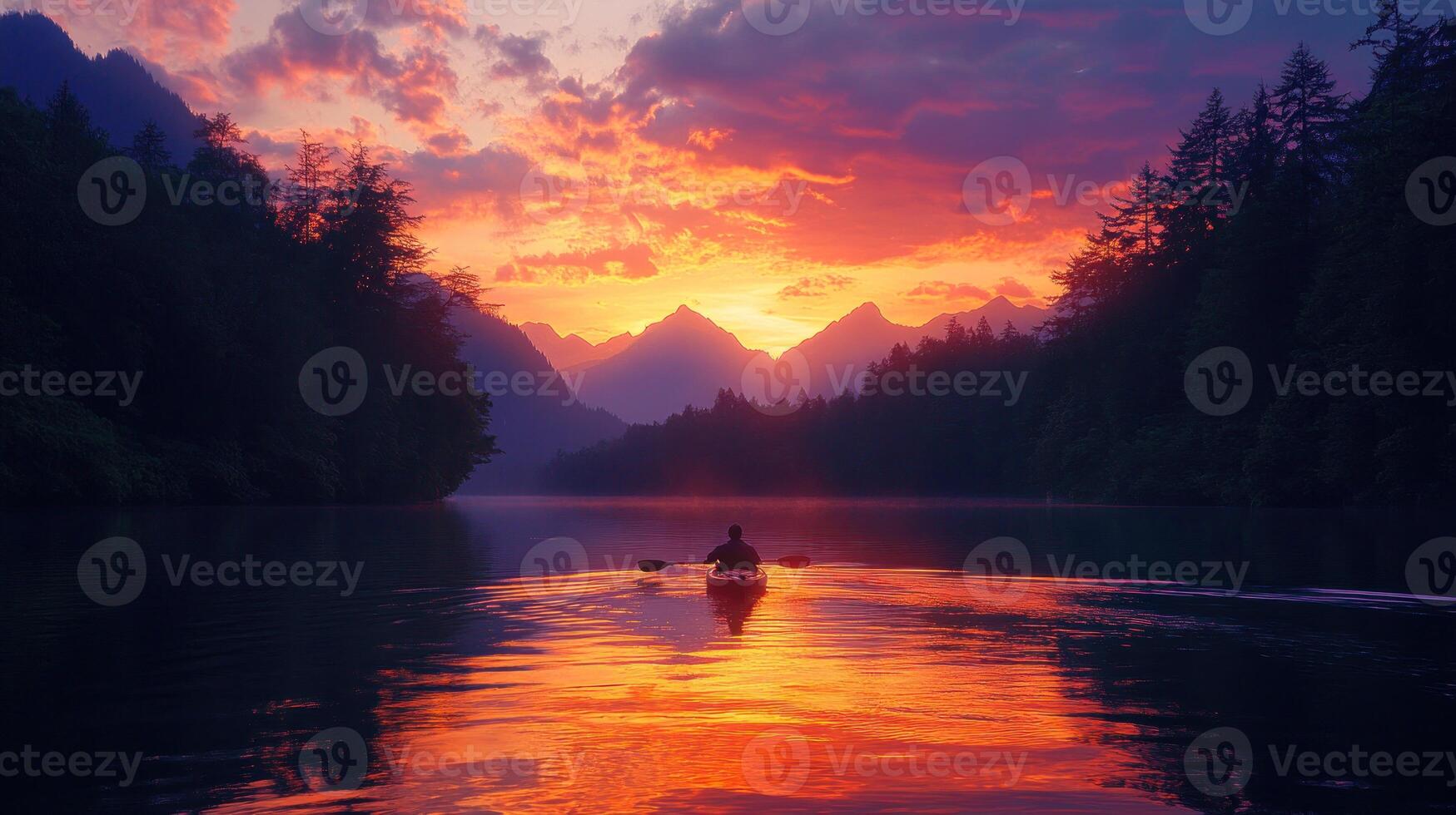 Solitary Kayaker at Sunset on a Still Mountain Lake photo