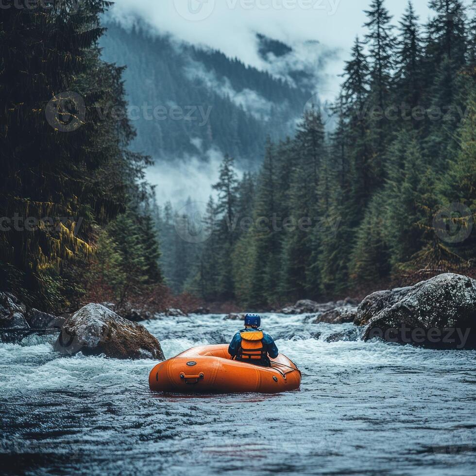 Solo Rafter Navigating a River Through a Misty Forest photo