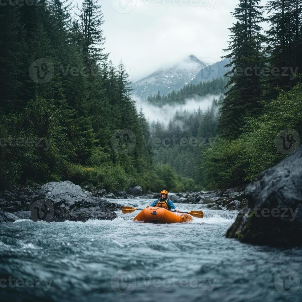 Solo Kayaker Navigating a Swift River Through a Foggy Mountain Forest photo