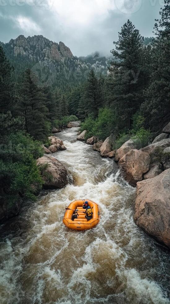 A yellow raft navigates a rushing river amidst mountainous terrain. photo