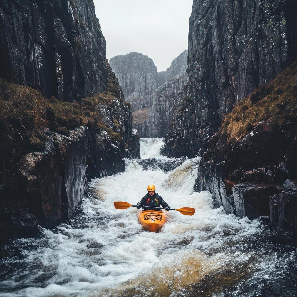 Kayaker Navigating a Fast-Moving River Through a Narrow Gorge photo