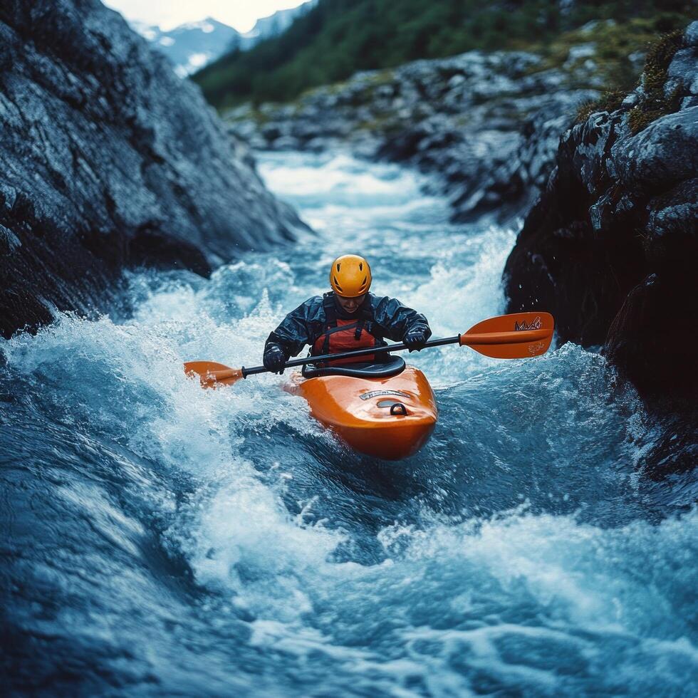 Kayaker Navigating a Rapid in a Mountain River Gorge photo