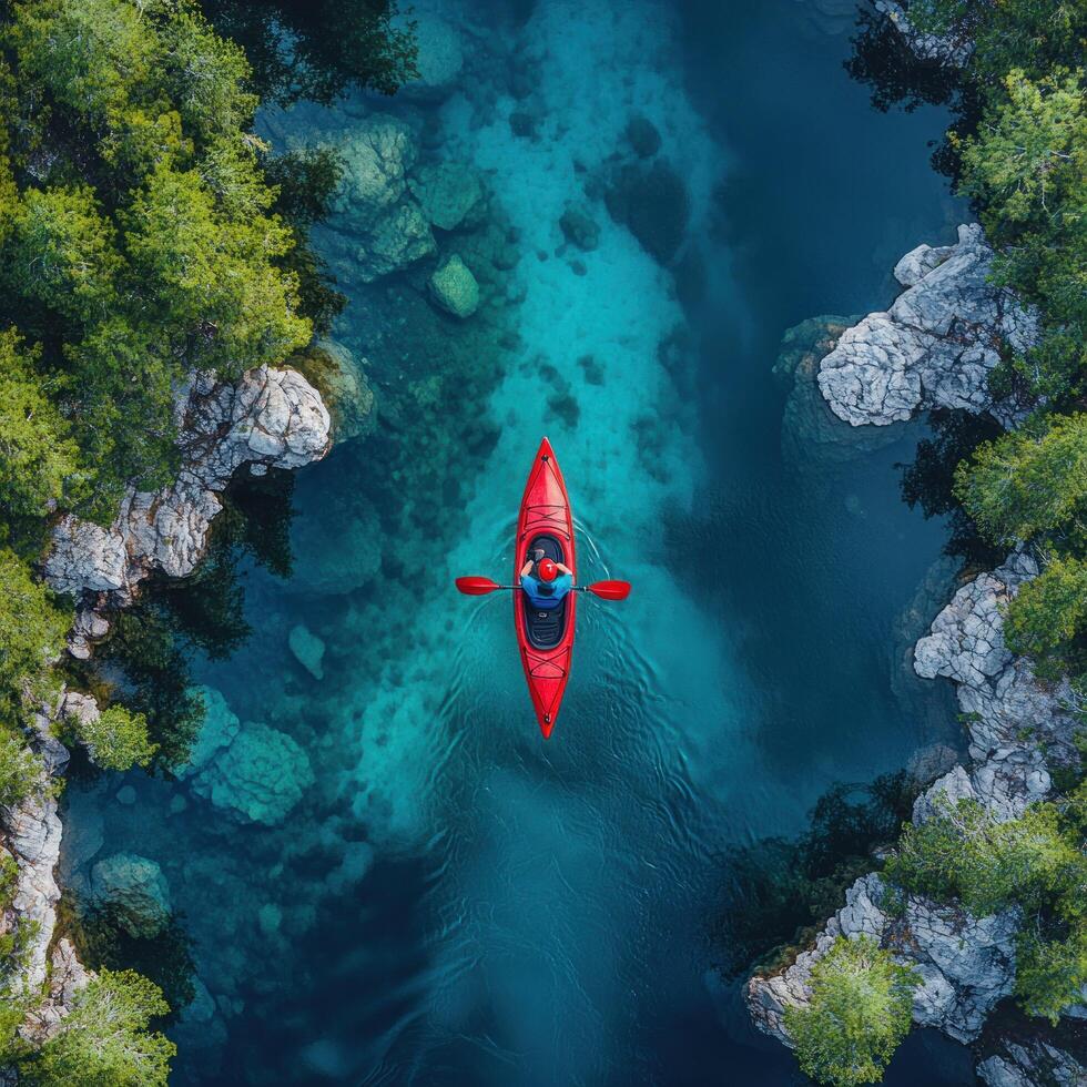 Aerial View of a Red Kayak in a Turquoise River Gorge photo