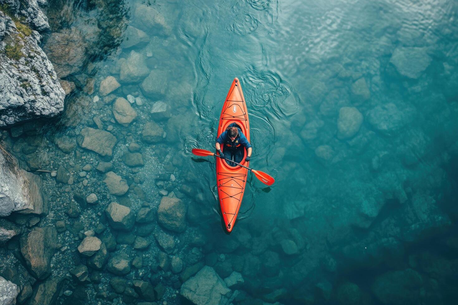 Overhead View of a Single Person Kayaking in a Tranquil Lake photo