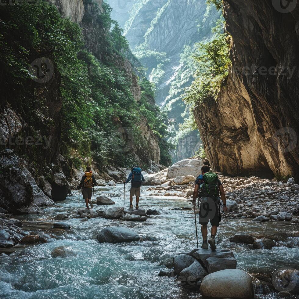 Hikers Trekking Through a Mountain Gorge with a Stream photo