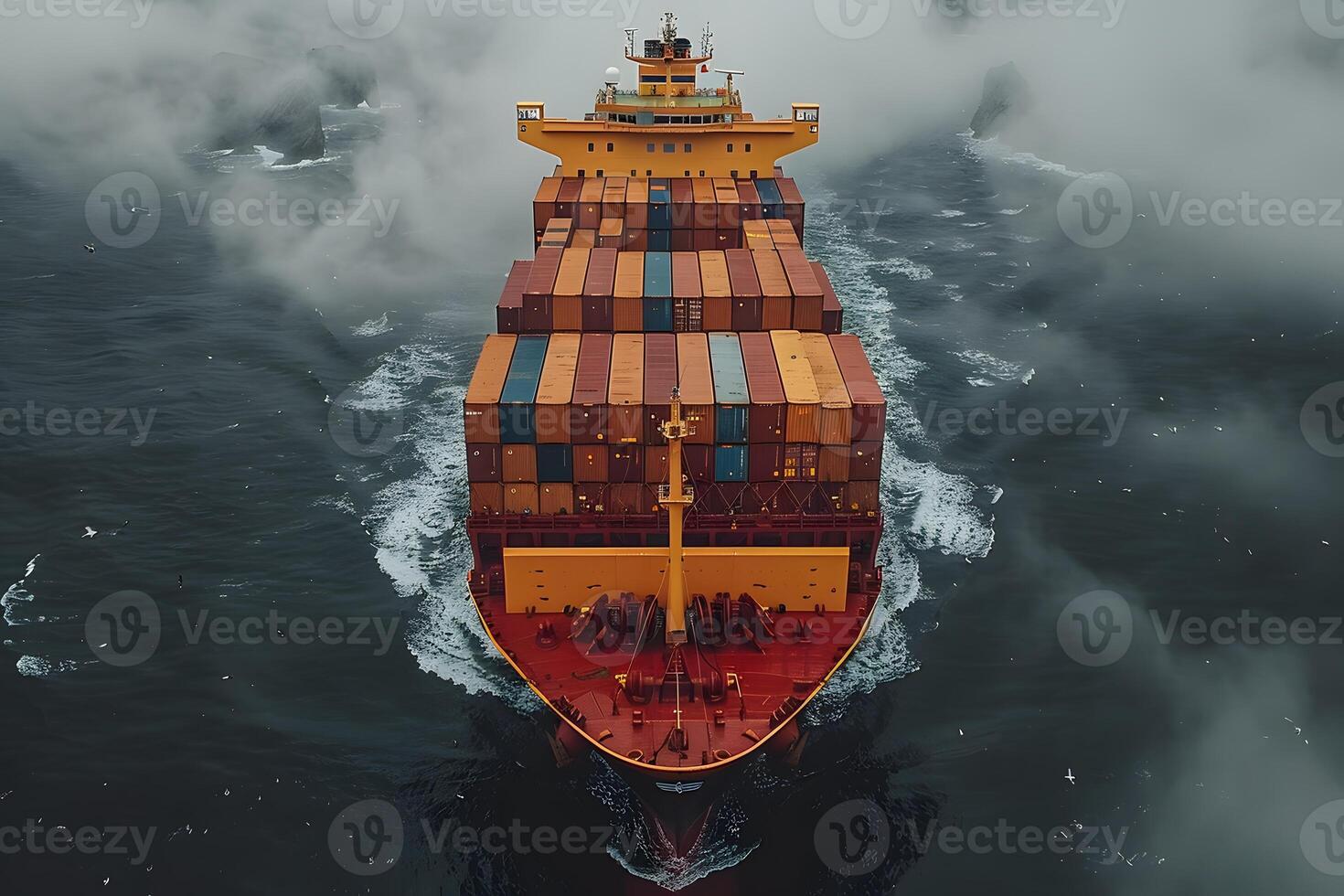 Aerial View of Cargo Ship Navigating Through Misty Ocean Waters photo