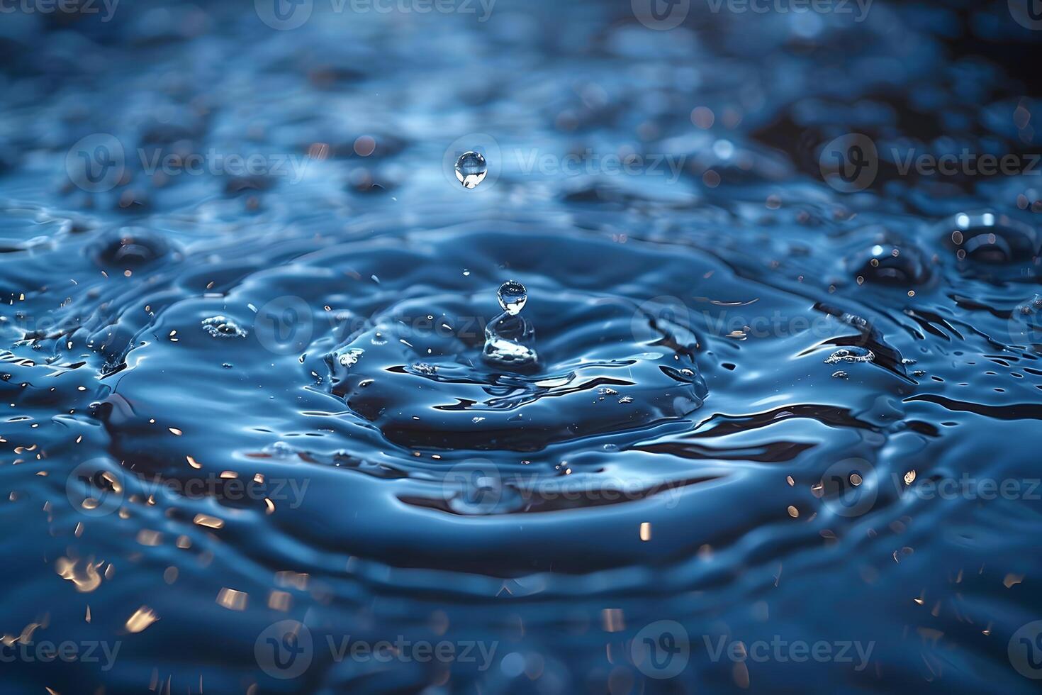 Droplet Splash in Blue Water Creating Ripples and Reflective Patterns for Nature Photography photo