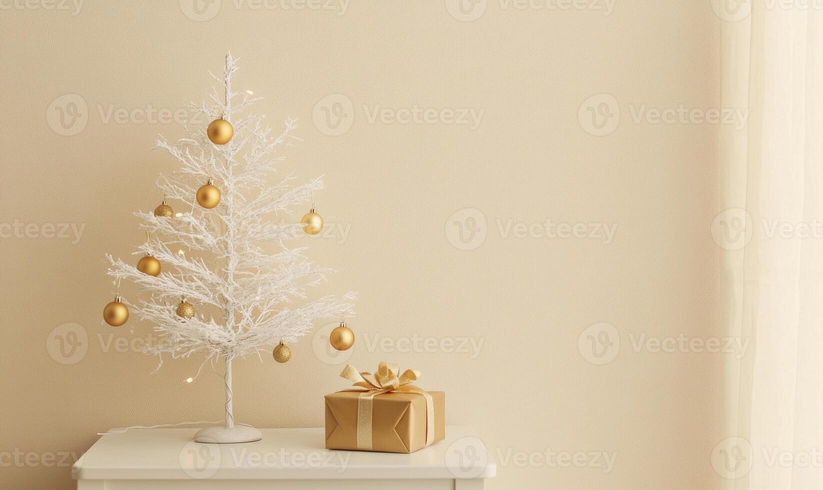 A white Christmas tree with gold ornaments sits on a table next to a brown box photo