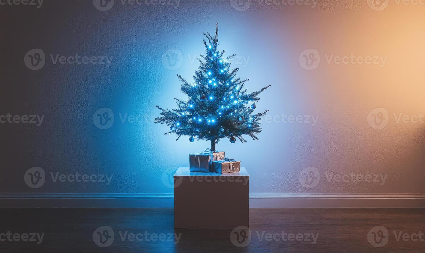 A small Christmas tree is lit up with blue lights and sits on a white box photo