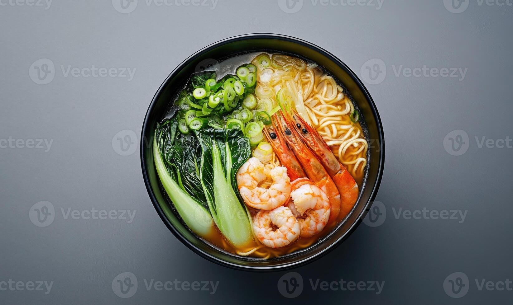 A bowl of soup with shrimp and vegetables photo