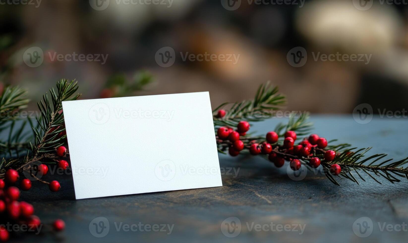 A white card is sitting on a table with red berries photo