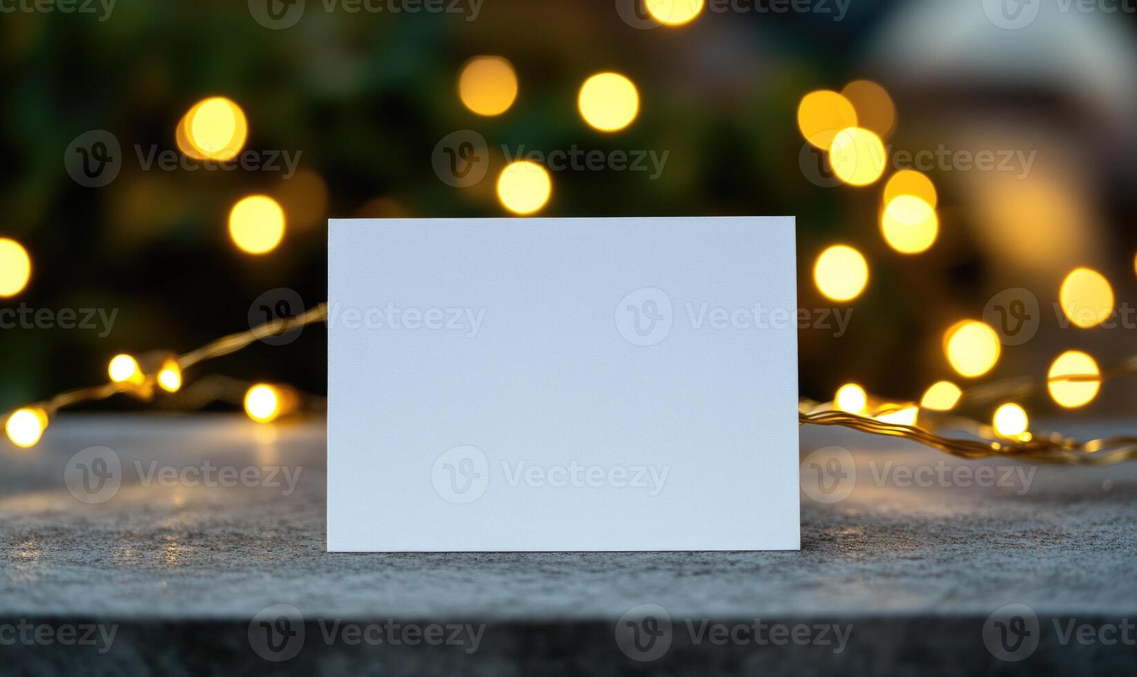 A white card with a blank space sits on a table photo